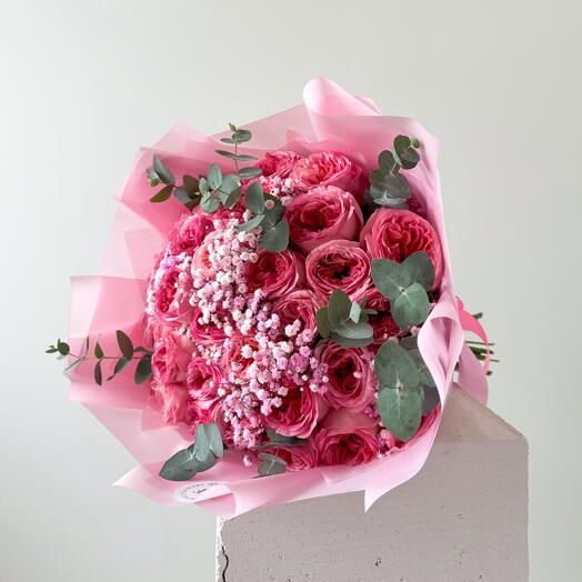 Pink peony roses bouquet with gypsophila and eucalyptus