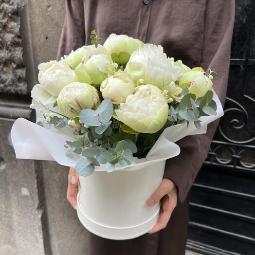 Basket with peonies and lilies of the valley