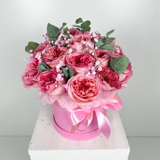 Pink peony roses in a box with gypsophila and eucalyptus