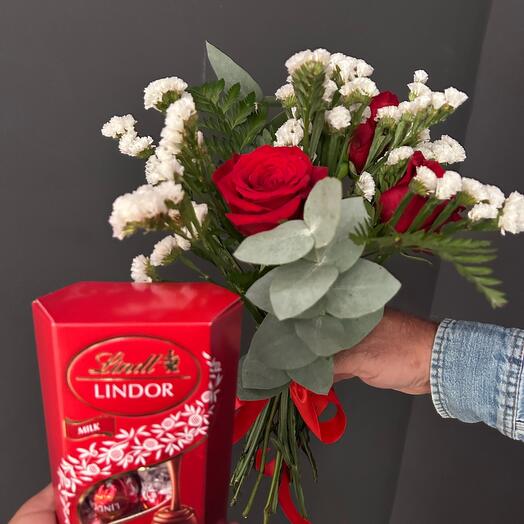 A bouquet of roses and chocolate candies
