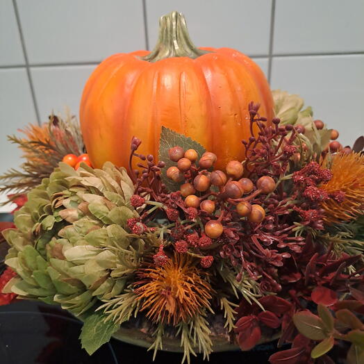Pumpkin with decorative flowers and berries