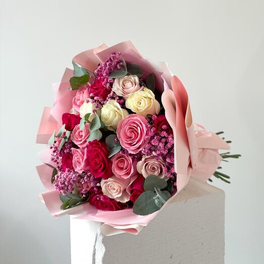 Pink and white roses mix with gypsophila and eucalyptus