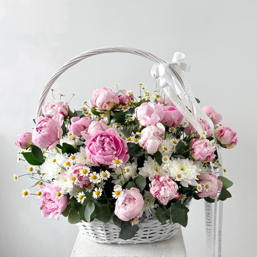 Pink peonies with daisies in a basket