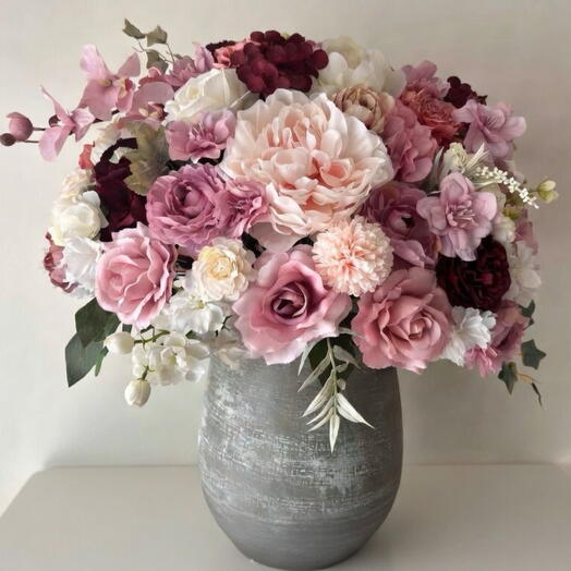 Large pink and dark pink artifical flower bouquet in a vase