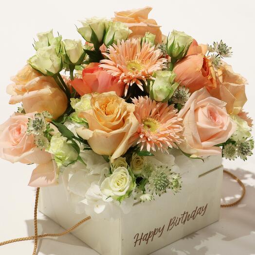 Happy Birthday Box, filled with beautiful Flowers, all in peach and cream colours