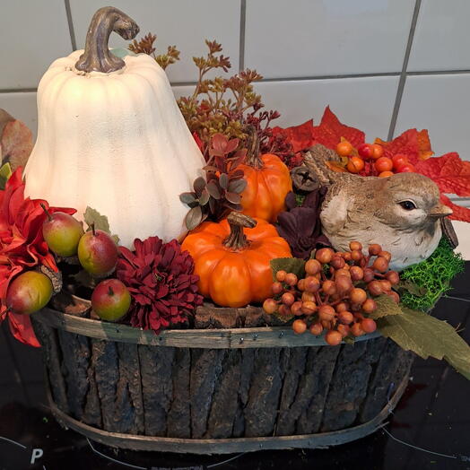 Set of pumpkins in flower pots with decorative leaves and berries