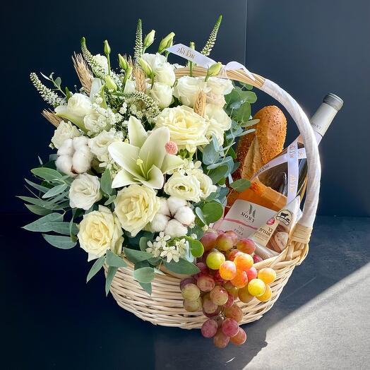 Large basket with flowers and wine