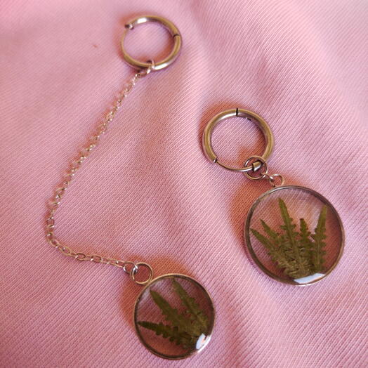 Asymmetric earrings with fern