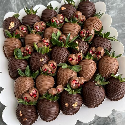 Chocolate covered strawberries and pomegranate