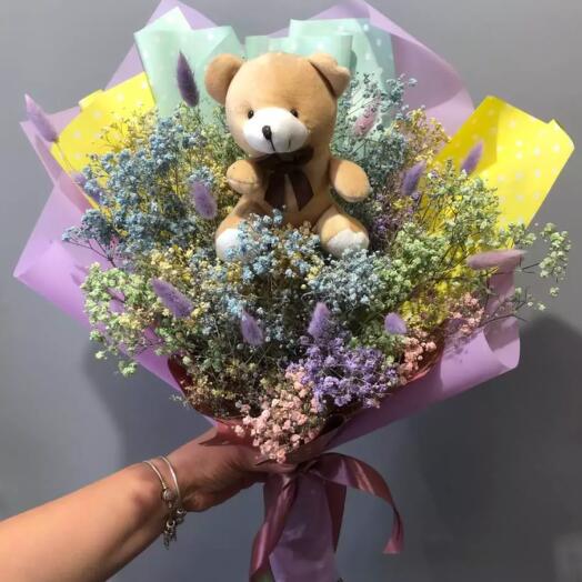 Bouquet with gypsophila and a teddy bear