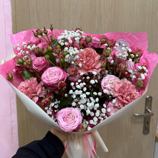 Delicate bouquet of spray roses with carnations