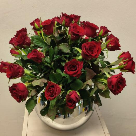 Red roses in fish bowl