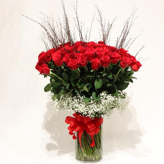 101 tall Red Roses in a matching glass vase
