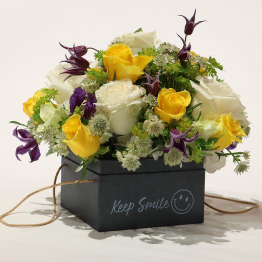 Keep Smiling box, filled with beautiful Flowers, all in yellow, white and purple