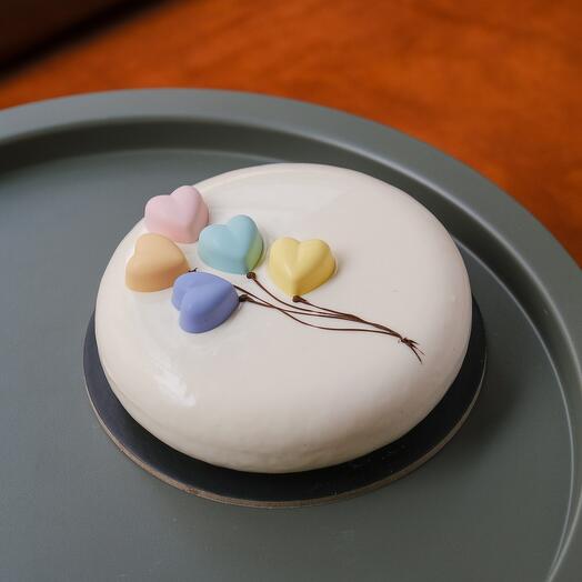 Love Cake with Callebaut chocolate white mousse, pistacio and raspberry jam